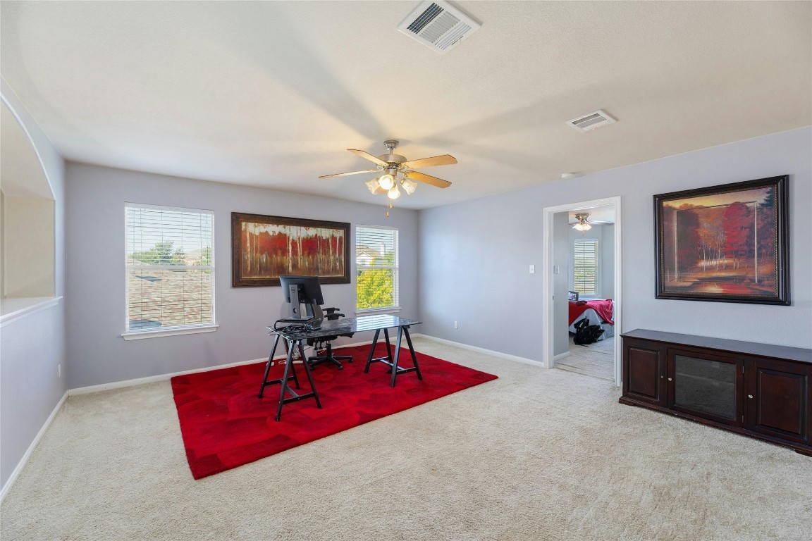 18401 Masi Loop Pflugerville, TX 78660 - Photo 19 of 29 Office with a ceiling fan, carpet flooring, and plenty of natural light