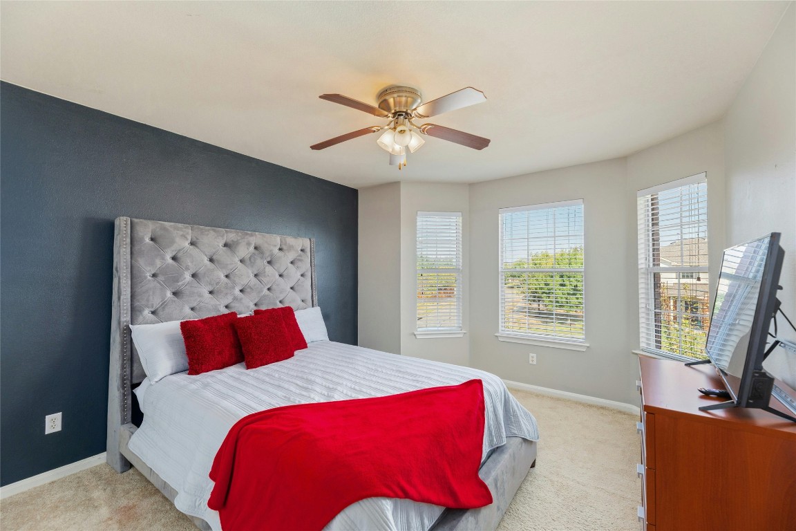 18401 Masi Loop Pflugerville, TX 78660 - Photo 21 of 29 Carpeted bedroom featuring baseboards and ceiling fan