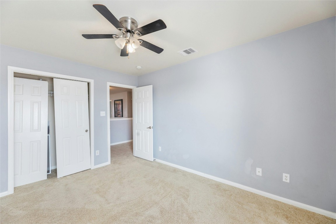 18401 Masi Loop Pflugerville, TX 78660 - Photo 23 of 29 Unfurnished bedroom with carpet, a closet, and ceiling fan