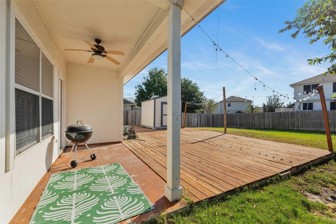 18401 Masi Loop Pflugerville, TX 78660 - Photo 26 of 29 Deck with a storage shed, a fenced backyard, ceiling fan, and grilling area
