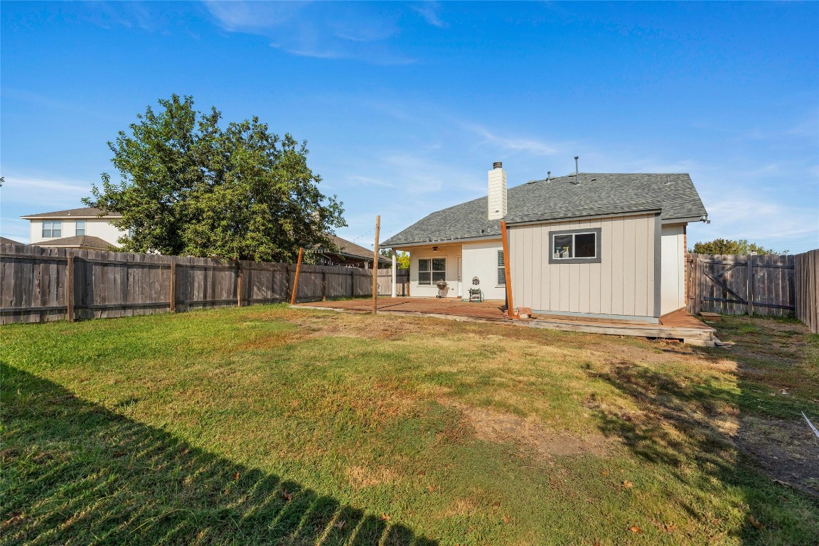18401 Masi Loop Pflugerville, TX 78660 - Photo 28 of 29 Back of house featuring a fenced backyard, a chimney, a patio area, and a shingled roof