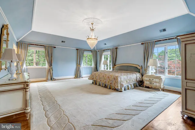 a bedroom with a large bed and a large window