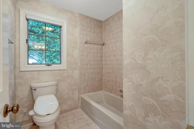 a bathroom with a toilet a sink and bathtub