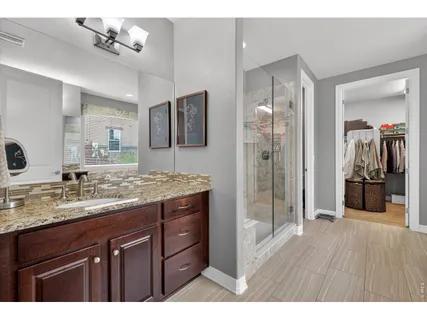 a bathroom with a tub shower and a sink