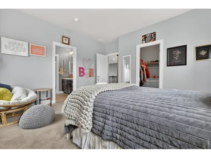 a bed room with a bed and a chair