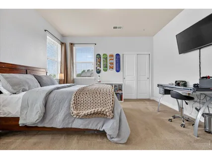 a bedroom with a bed and a tv