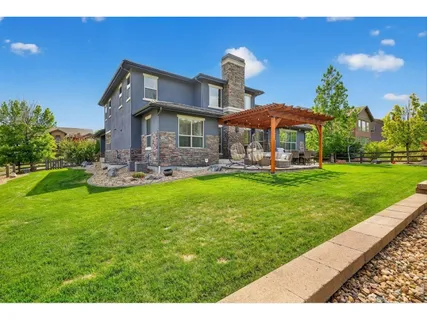 a backyard of a house with table and chairs