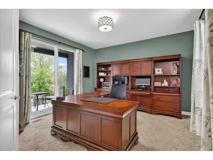a living room with furniture a flat screen tv and a large window