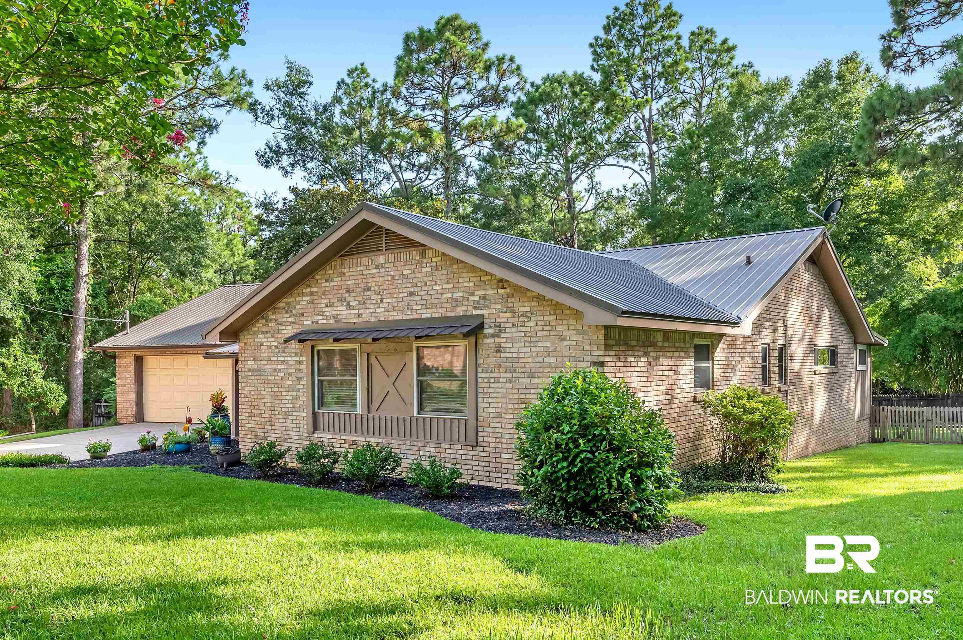 104 James Circle Daphne, AL 36526 - Photo 4 of 62 View of side of property with a garage and a yard