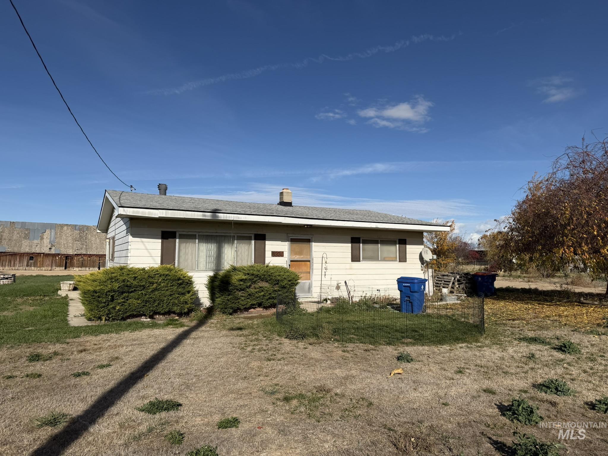 5220 West Ustick Road Meridian, ID 83646 - Photo 2 of 5 View of front of property with a chimney, a front lawn, and roof with shingles