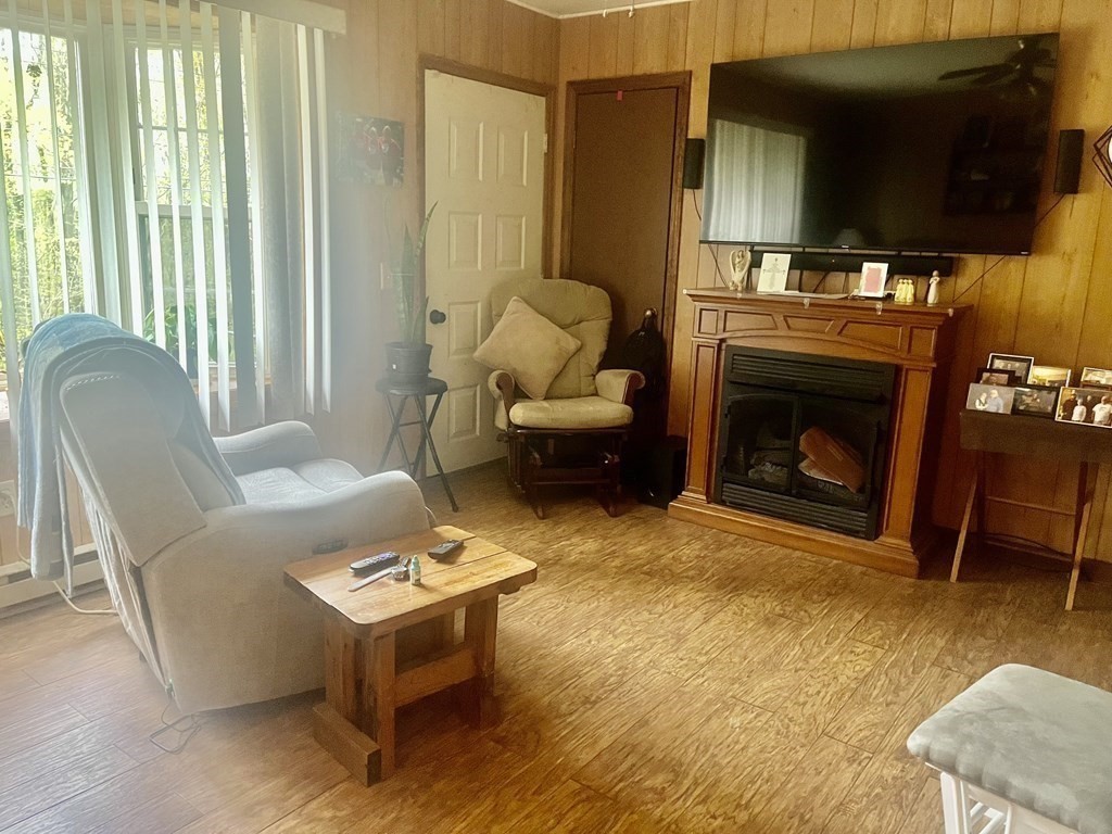30 Podunk Road Sturbridge, MA 01566 - Photo 3 of 13 a living room with furniture a flat screen tv and a fireplace