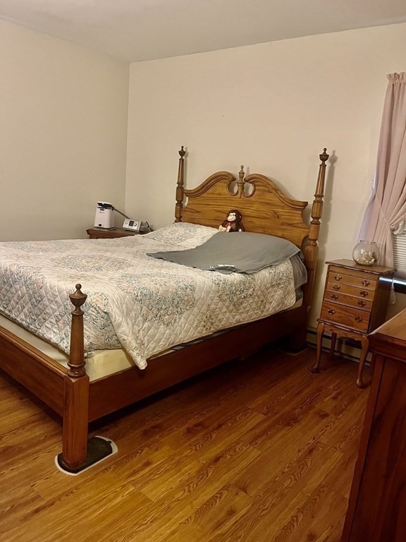 30 Podunk Road Sturbridge, MA 01566 - Photo 5 of 13 a bedroom with a bed and wooden floor