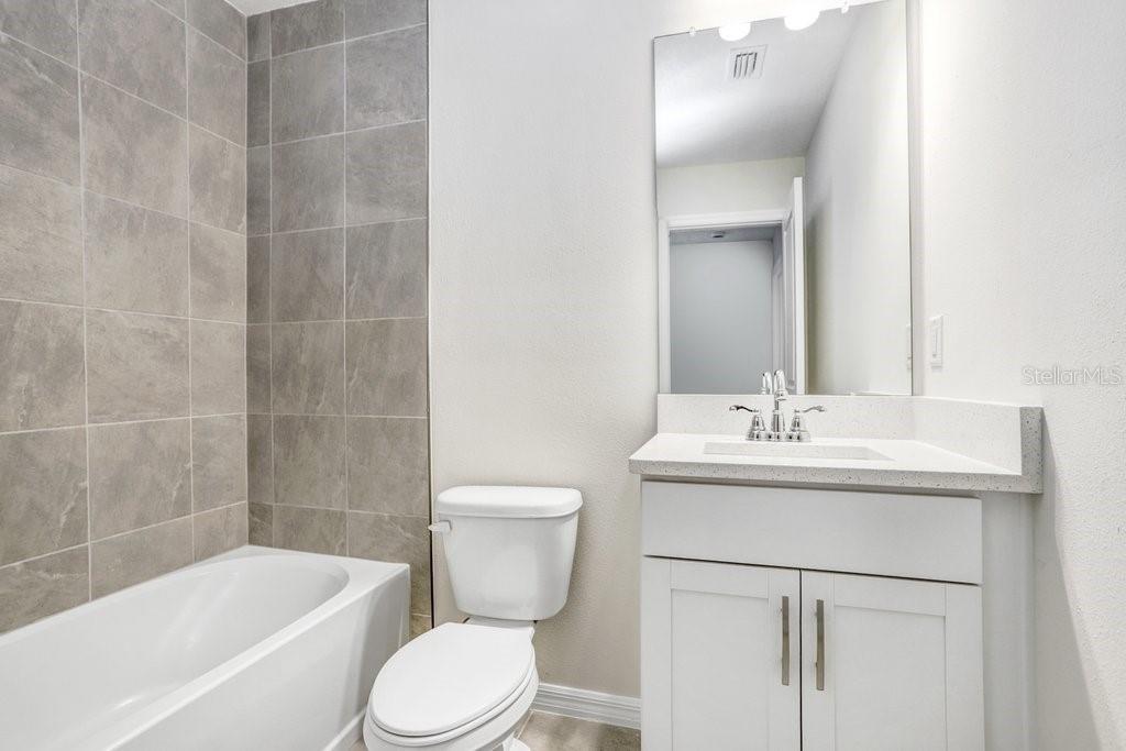 5343 Coldpine Place Seffner, FL 33584 - Photo 24 of 27 a bathroom with a sink toilet and shower