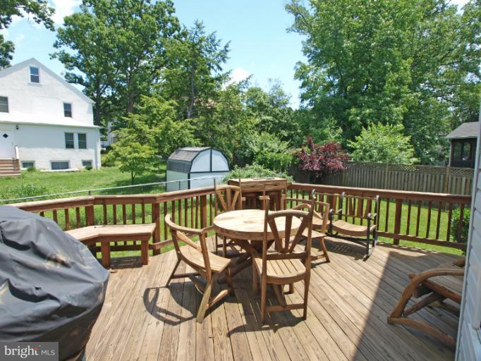 1167 Kersey Road Silver Spring, MD 20902 - Photo 22 of 25 a view of a balcony with chairs and wooden floor