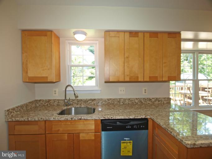 1167 Kersey Road Silver Spring, MD 20902 - Photo 7 of 25 a kitchen with a sink a counter top space and cabinets