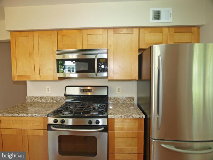 1167 Kersey Road Silver Spring, MD 20902 - Photo 8 of 25 a kitchen with a stove and a refrigerator
