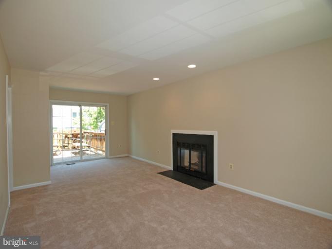 1167 Kersey Road Silver Spring, MD 20902 - Photo 10 of 25 a view of an empty room with a fireplace and a window