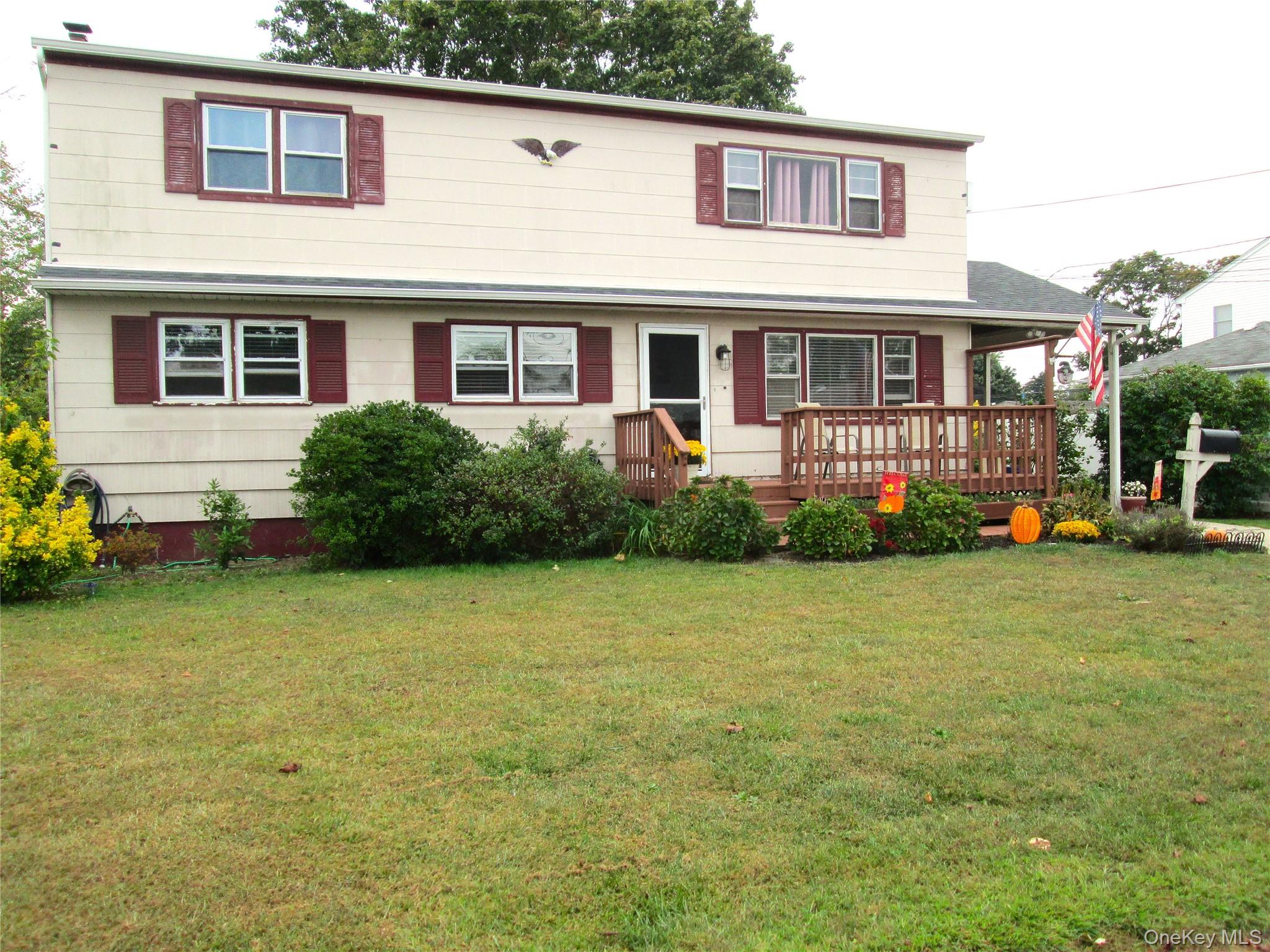 353 49th Street Lindenhurst, NY 11757 - Photo 1 of 1 a front view of a house with garden