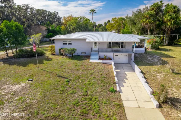 a living room with furniture a ceiling fan and a rug