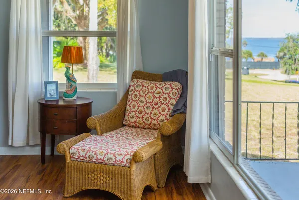 a view of a dining room with furniture a chandelier and wooden floor