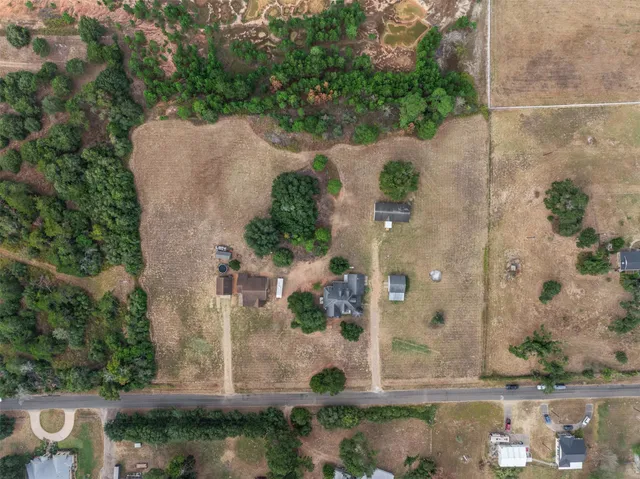 an aerial view of a house with a yard