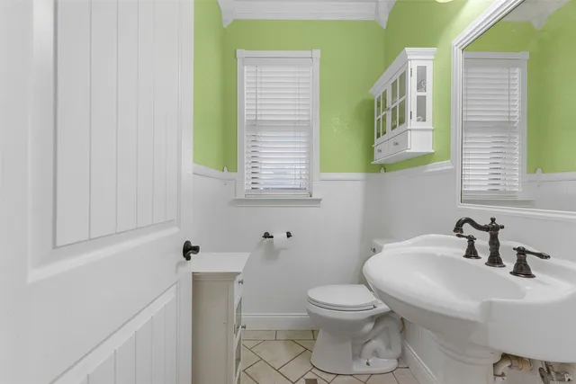 a bathroom with a sink a toilet and mirror