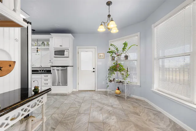 a view of kitchen with refrigerator and window