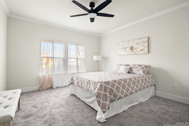 a spacious bedroom with a bed and window