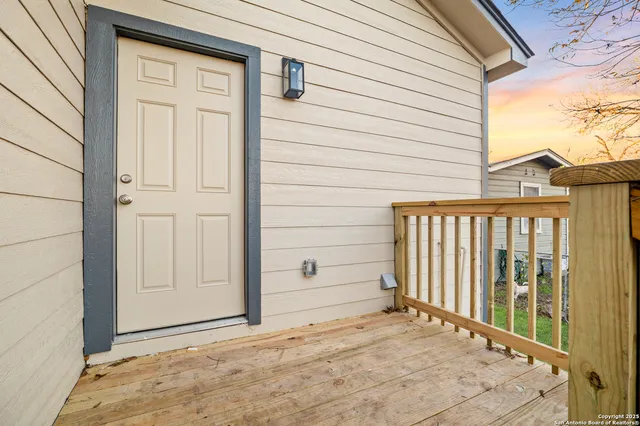 a view of a house with a wooden fence