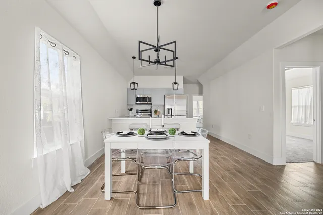 a dining room with furniture and window