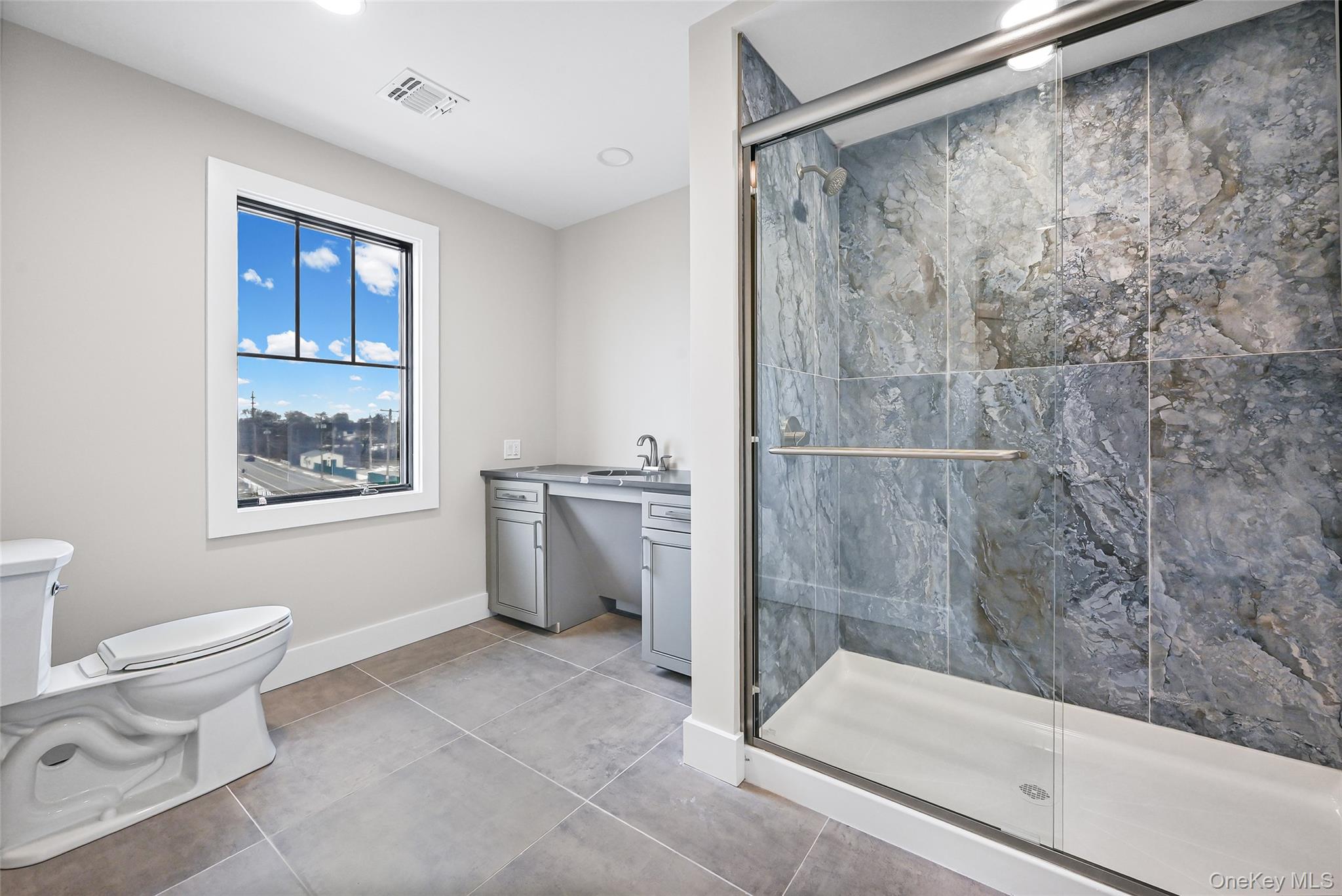 80 Division Street, Unit 3A Patchogue, NY 11772 - Photo 12 of 18 Bathroom with vanity, a shower stall, light tile patterned floors, and recessed lighting