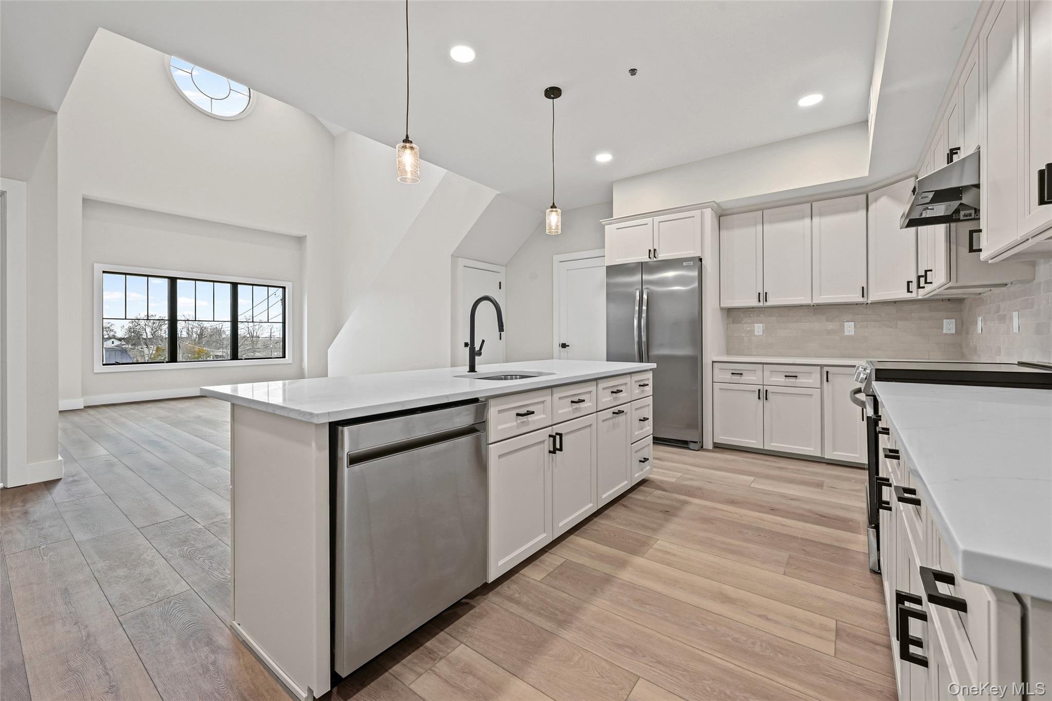 80 Division Street, Unit 3A Patchogue, NY 11772 - Photo 4 of 18 Kitchen featuring tasteful backsplash, appliances with stainless steel finishes, white cabinetry, and recessed lighting