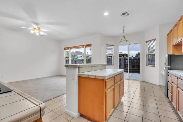 a kitchen with stainless steel appliances granite countertop a sink and a stove