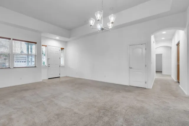 a view of an empty room with a chandelier
