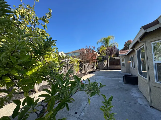 a view of a house with a backyard
