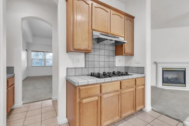 a kitchen with cabinets a stove top oven and sink