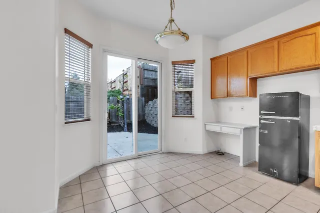 a kitchen with a refrigerator a sink and cabinets