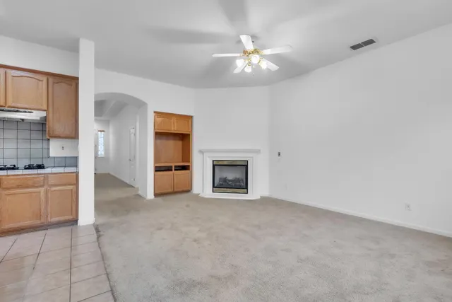 a view of an empty room with a kitchen