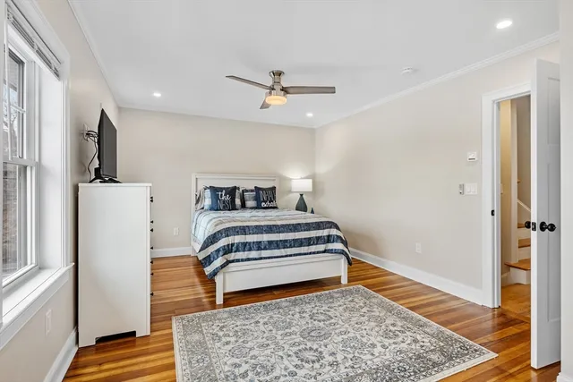 a bedroom with a bed and wooden floor