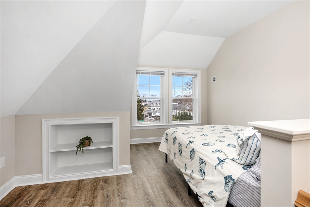 242 Atlantic Avenue, Unit 2 Hull, MA 02045 - Photo 16 of 21 a bedroom with a bed and a window