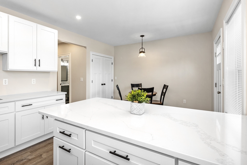 242 Atlantic Avenue, Unit 2 Hull, MA 02045 - Photo 5 of 21 a kitchen with a white cabinets and chandelier