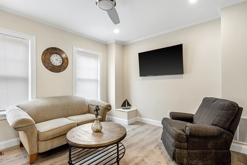 242 Atlantic Avenue, Unit 2 Hull, MA 02045 - Photo 10 of 21 a living room with furniture and a flat screen tv