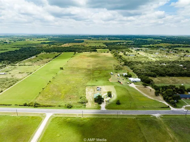 a dining room with furniture wooden floor a painting and a chandelier