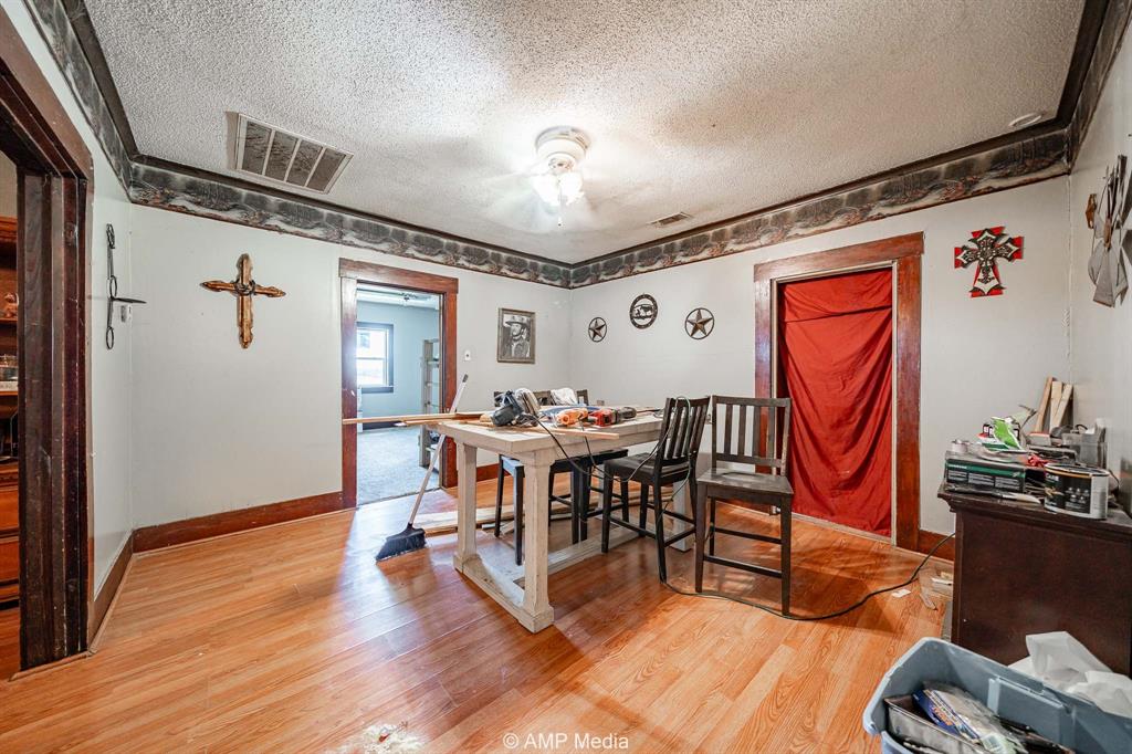 3255 Farm To Market 604 Clyde, TX 79510 - Photo 29 of 36 a dining room with furniture wooden floor a painting and a chandelier