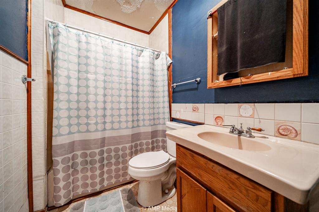 3255 Farm To Market 604 Clyde, TX 79510 - Photo 31 of 36 a bathroom with a sink toilet a mirror and shower