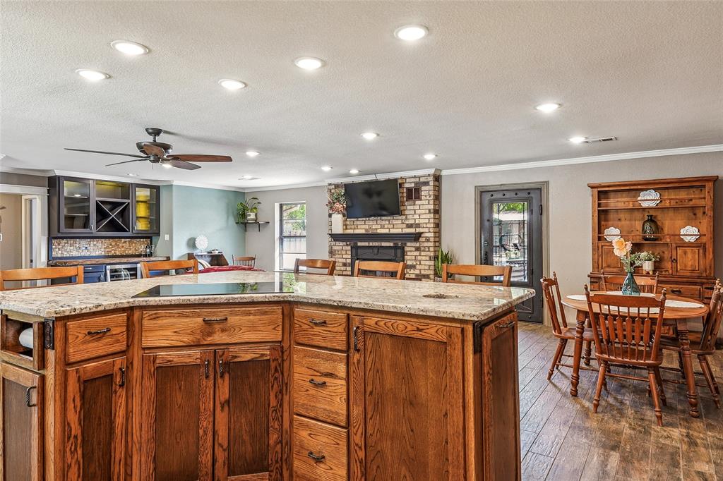 908 North Maple Street Muenster, TX 76252 - Photo 11 of 40 a kitchen with lots of counter top space and painting on the wall