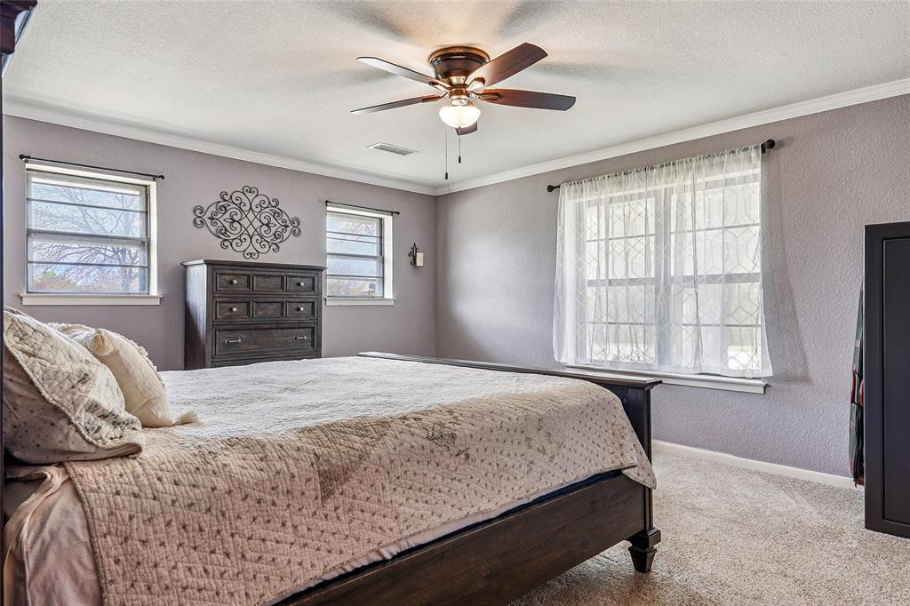 908 North Maple Street Muenster, TX 76252 - Photo 15 of 40 a bedroom with a bed dresser and a window