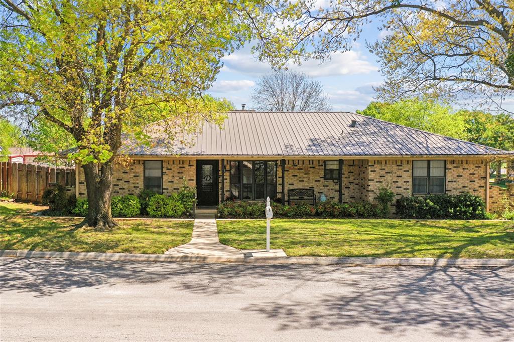 908 North Maple Street Muenster, TX 76252 - Photo 2 of 40 a view of a house with a yard and sitting area