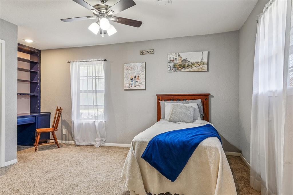 908 North Maple Street Muenster, TX 76252 - Photo 21 of 40 a bedroom with a bed and a window