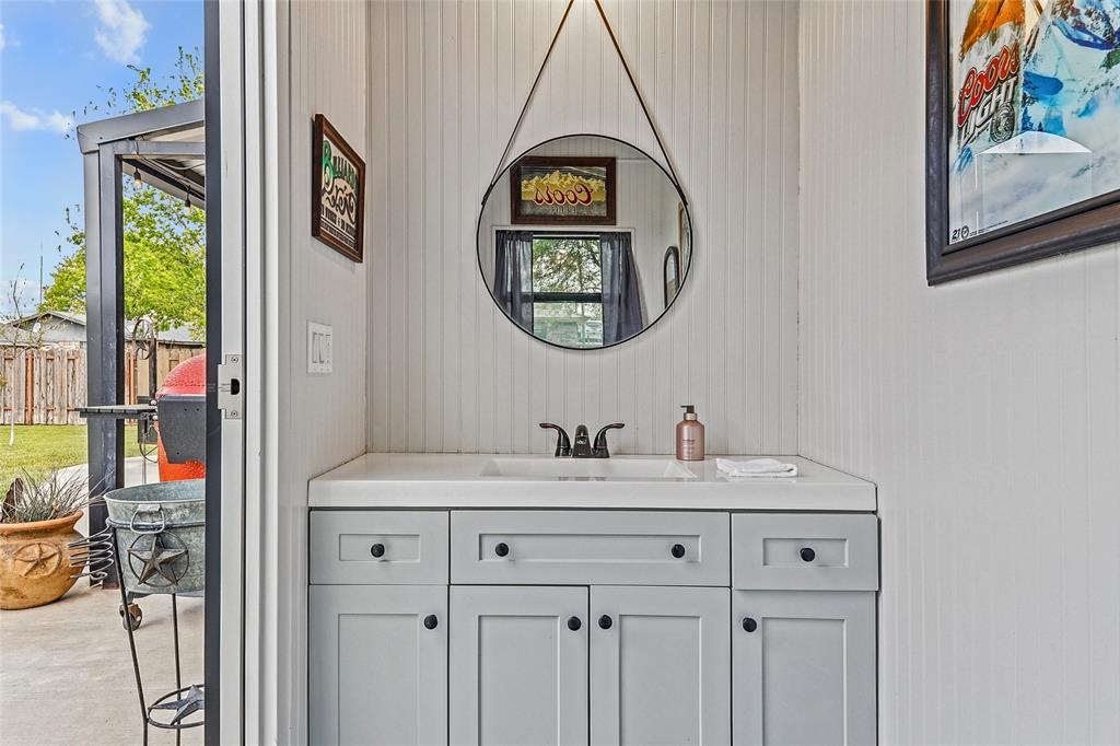 908 North Maple Street Muenster, TX 76252 - Photo 28 of 40 a bathroom with a sink and a mirror